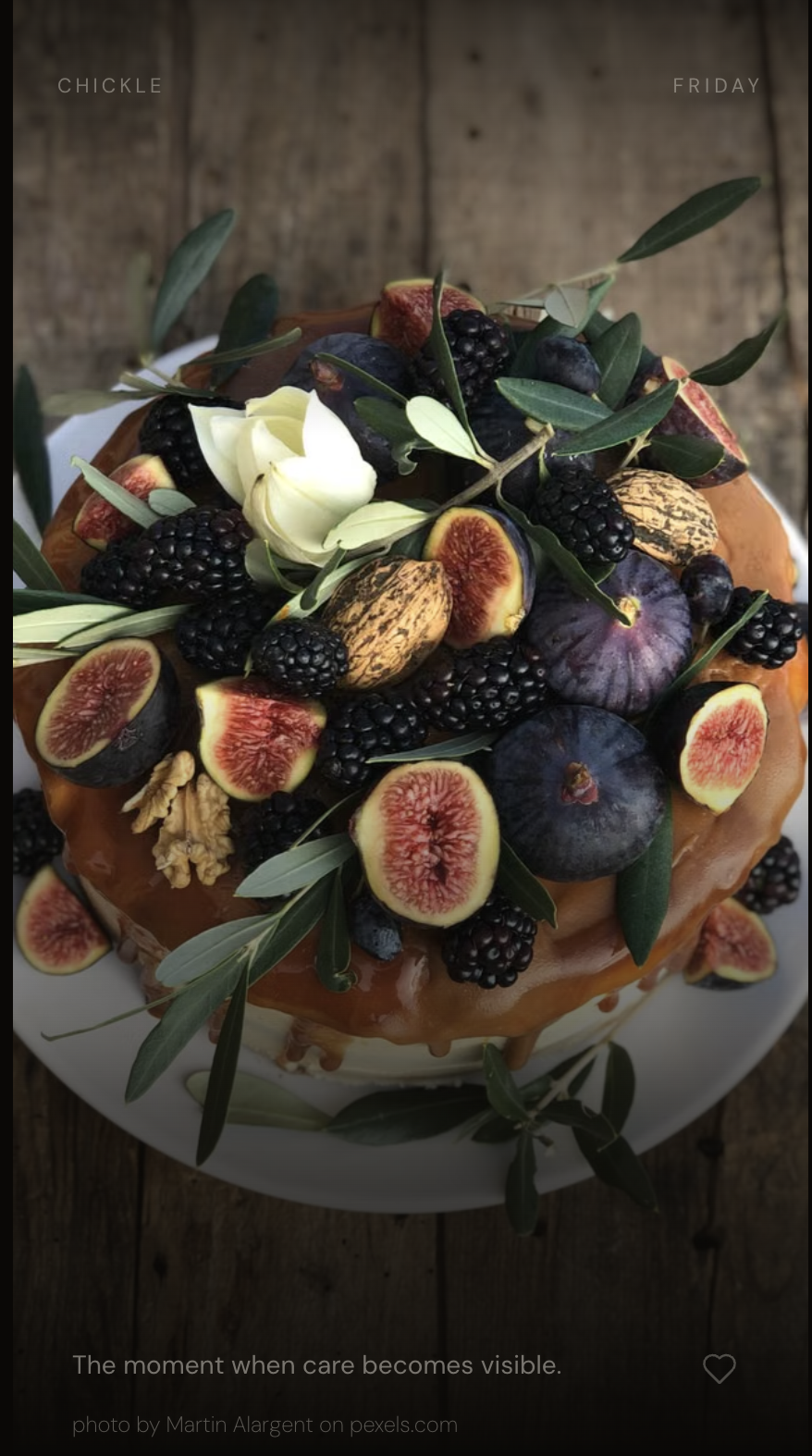 Chickle: a cake with figs, blackberries, and olive leaves on a dark wooden table, caption 'The moment when care becomes visible.'